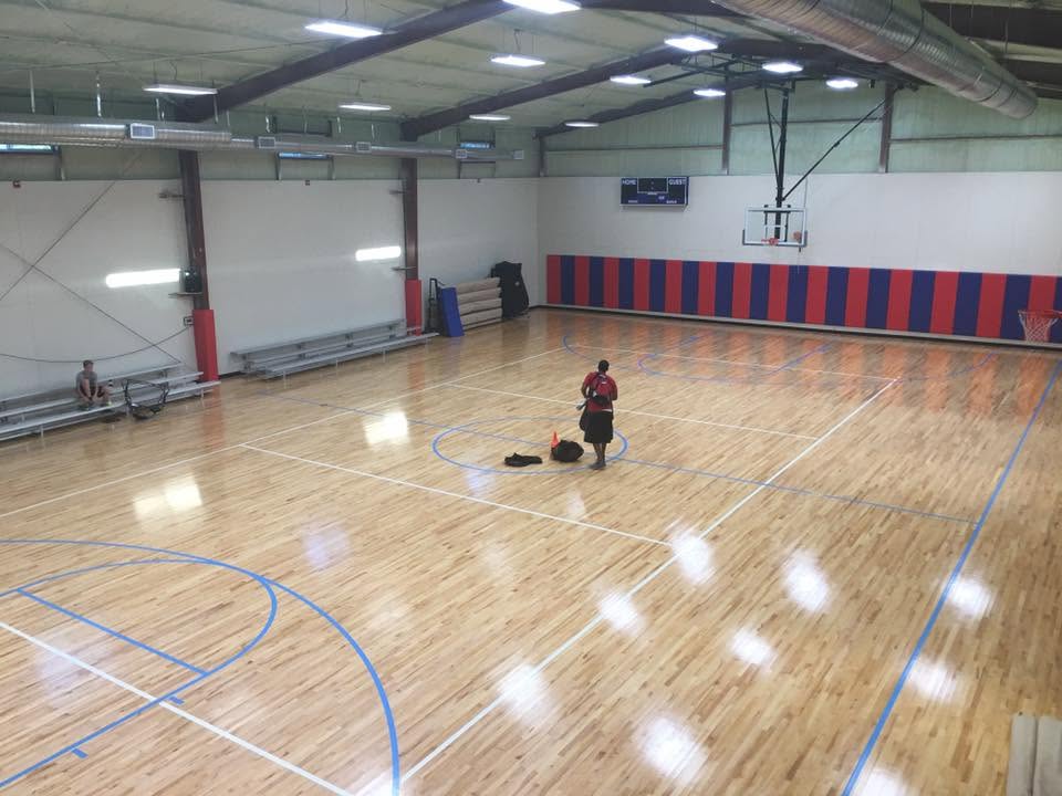 Indoor court with volleyball lines and net setup at Hilltop Court in Argyle, TX